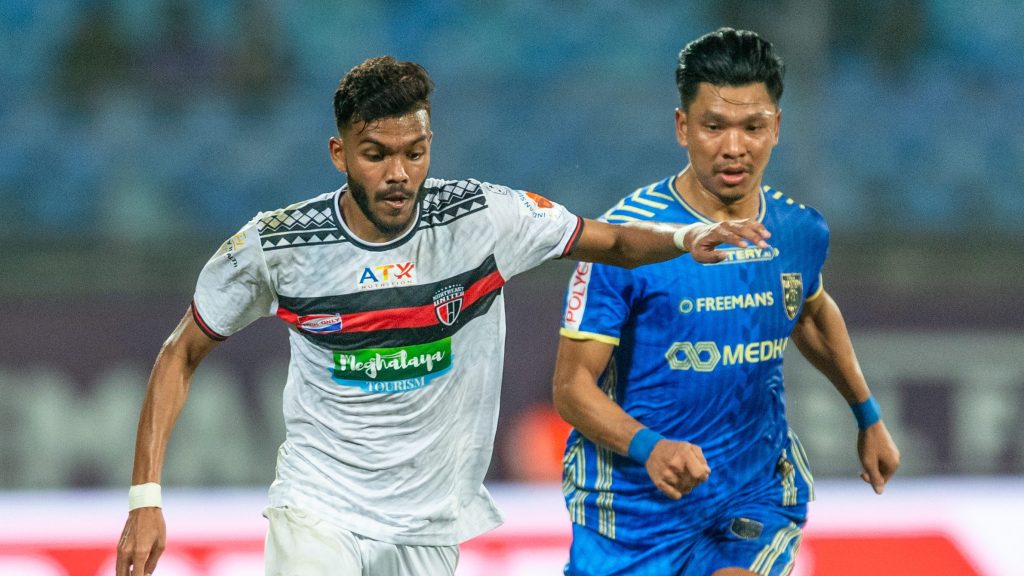 Northeast United midfielder Macarton and Kerala Blasters defender Sandeep Singh in action. 