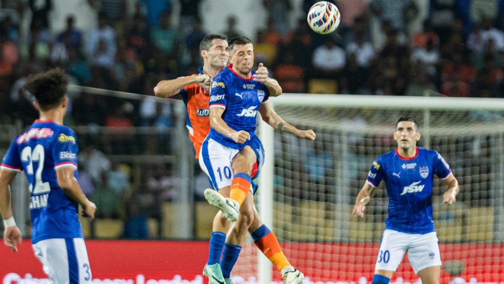 Alberto Noguera and Carl McHugh contesting for the ball in the air. 