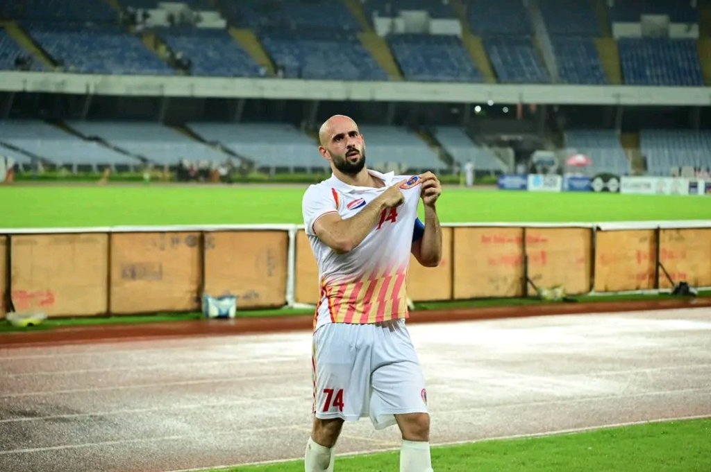 Mohammed Rashid pointing out to East Bengal badge
